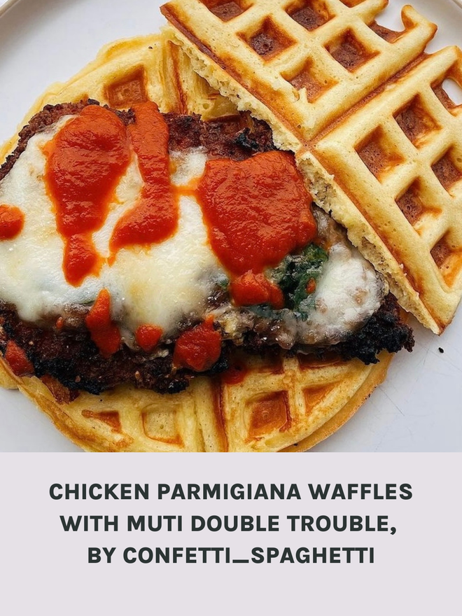 Picture Of a Chicken Parmigiana On A Waffle Drizzled With Muti Double Trouble Hot Sauce.