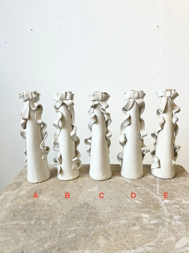 bow vases, 5 of them in a line 