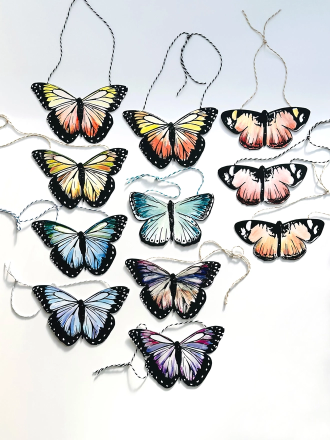 Hand Painted Butterfly Colourful Linocut Hanging Decorations In multiple colours laid out next to each other to show all of the colours available 
