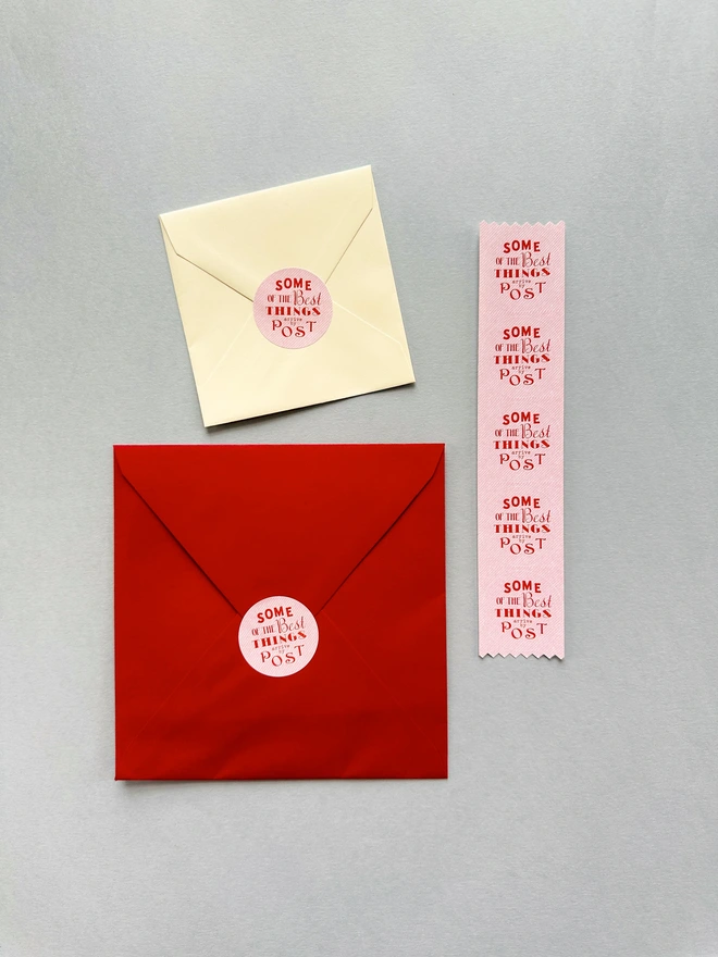 Set of 5 circular stickers with the phrase 'Some of the best things arrive by post.' Perfect for sealing envelopes with a charming touch. Ideal for adding a personal, decorative element to your mail. pink sticker red envelope