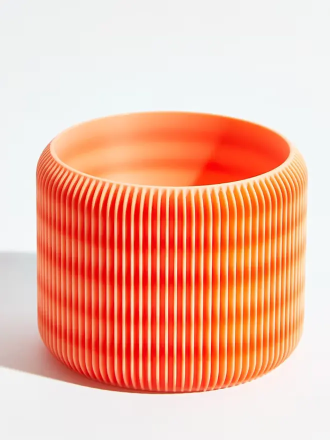 Sustainable 3D Printed Coral Orange Plant Pot, turbin design against a white background.