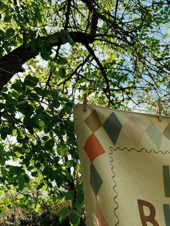 Heirloom Fabric Birthday Banner, hanging in a tree. 