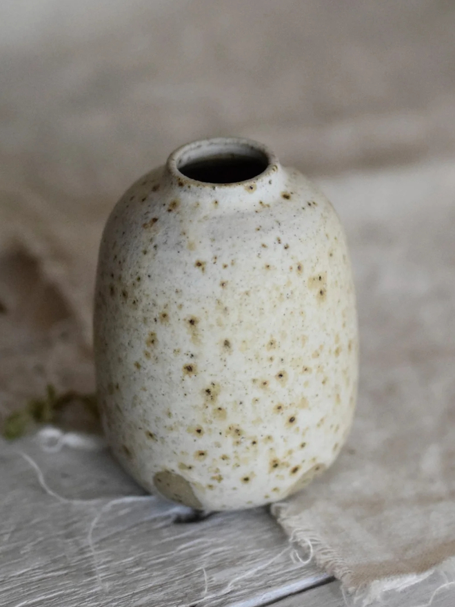 Ceramic bud vaseStoneware bud vase. A small stoneware handmade bud vase with a speckled glaze