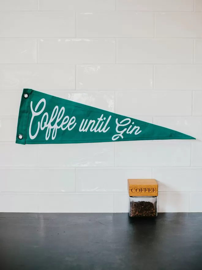 Coffee until gin caro b pennant flag seen on a wall.