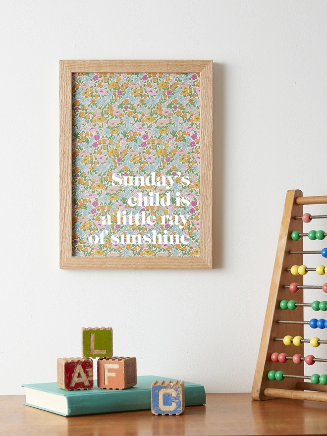 Sunday's child is a little ray of sunshine print on Liberty fabric with white typography