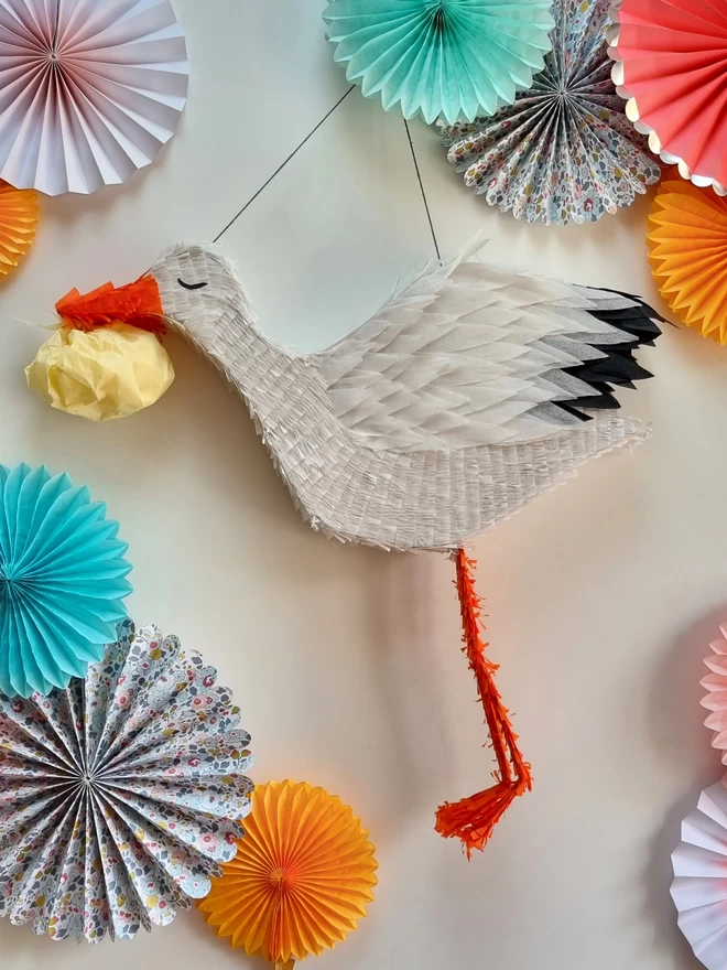 Stalk pinata for a baby shower surrounded by paper decorations