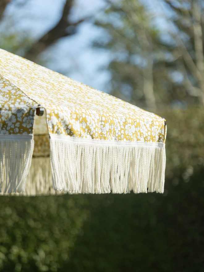 Liberty London Fringed Parasol. A parasol in fennel yellow.