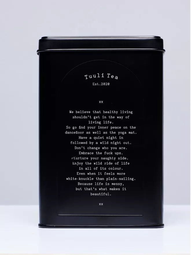 A black Tuuli Tea tin with a manifesto in white text.