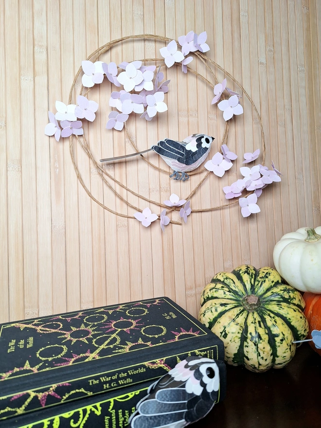 pink flower wreath featuring a little black, white and pink bird