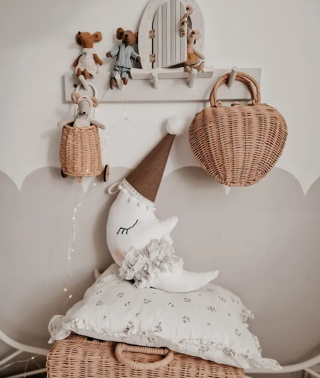 Hanging Moon Pillow Decoration, a hanging moon pillow decoration sitting against a wooden hamper accompanied by other bedding accessories. 
