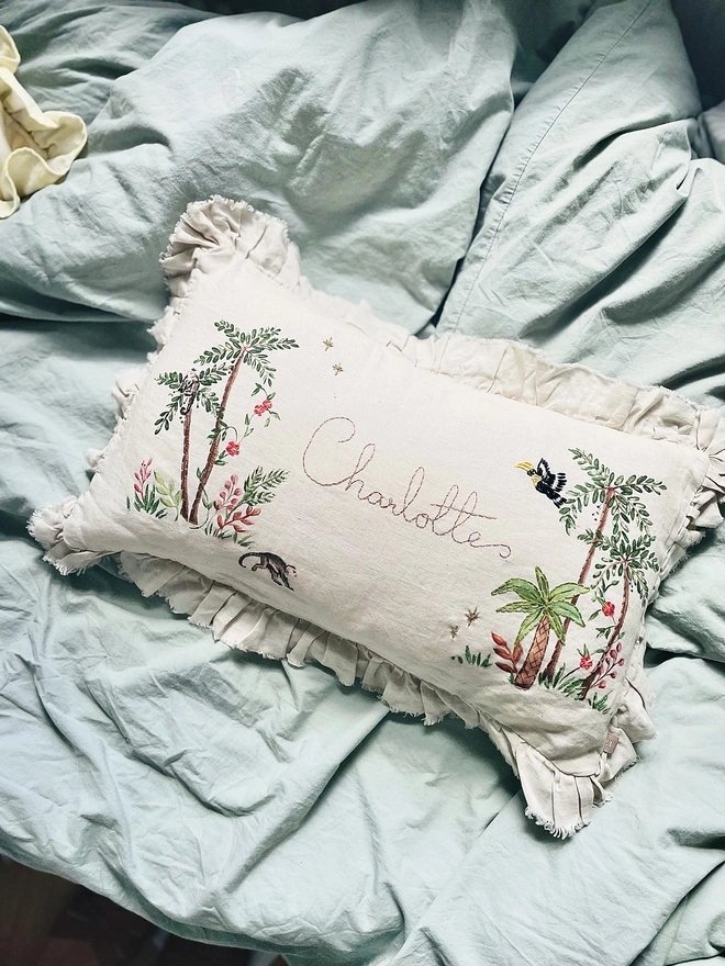 Hand Embroidered Tropical Jungle cushion on natural linen with personalised name 