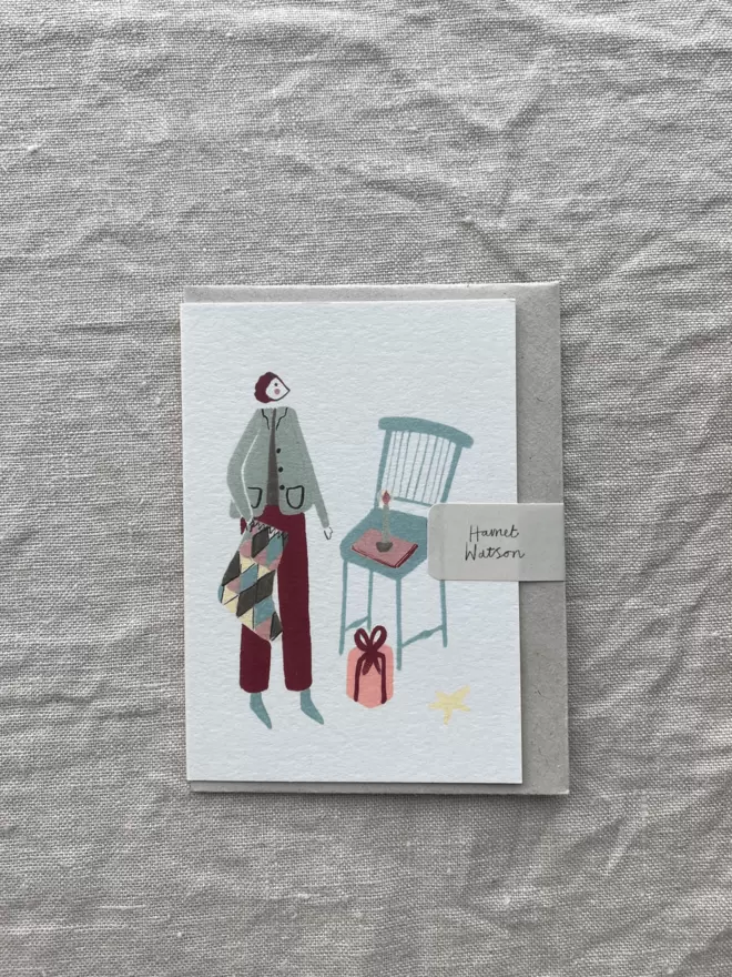 christmas card with present, stocking, candle and a present.