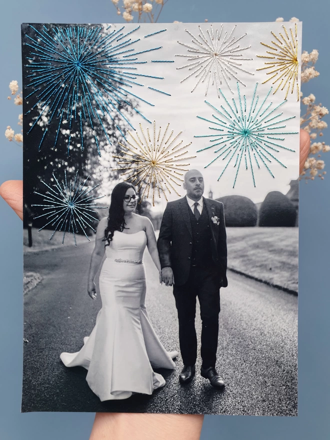  Wedding photo in B&W with hand embroidered sparkly fireworks held against blue background