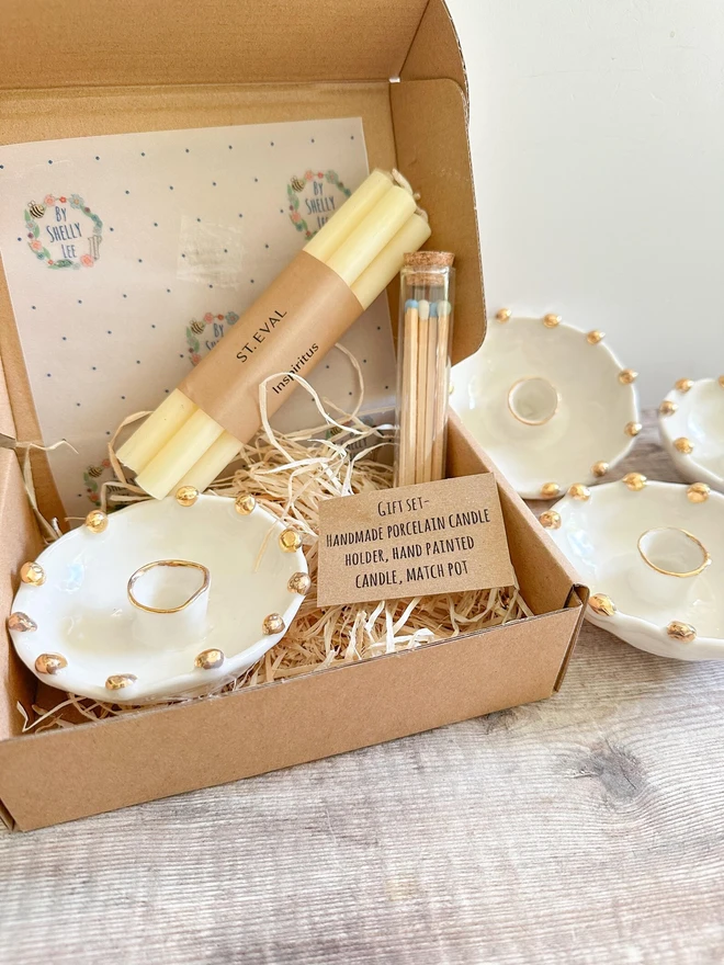 Handmade Gold Star Porcelain Candle Holder Gift (Set Of 3), gift set packaged on a cardboard box on a table. 