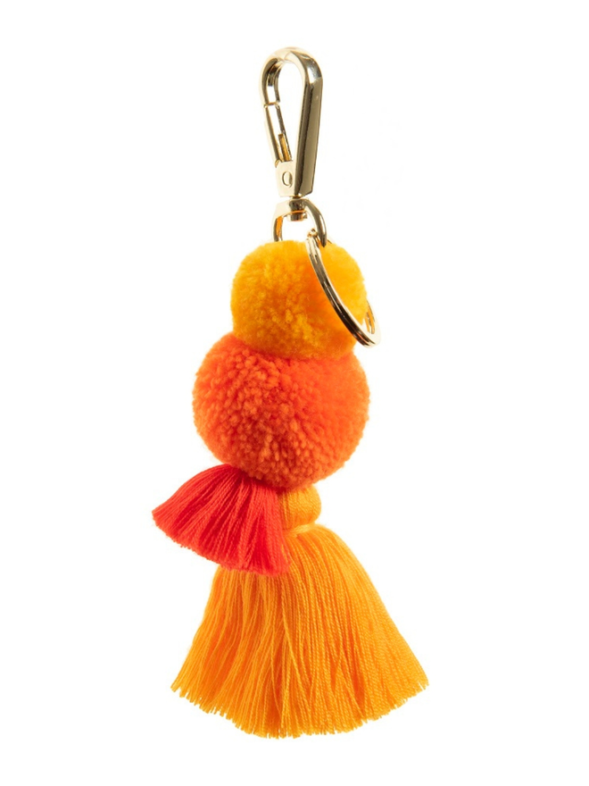 pom pom and tassel keyring. a keyring with orange pom poms and tassels.