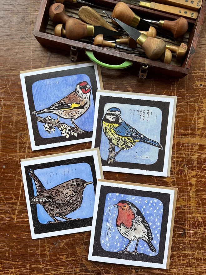four linocut watercolour garden bit=rd cards blu tit goldfinch wren robin