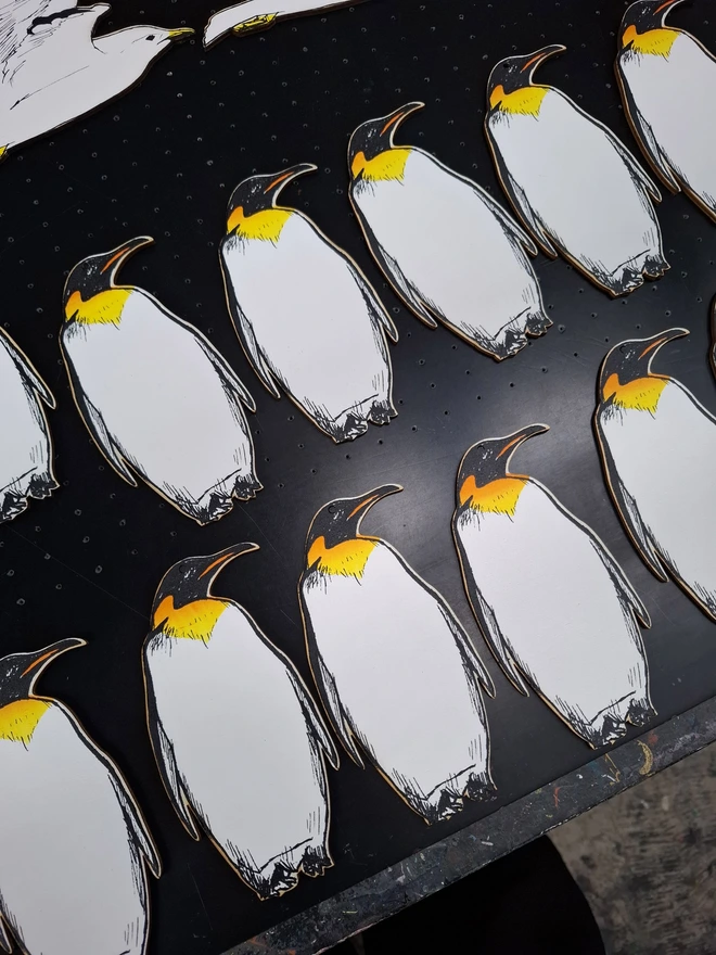 Penguin Christmas decoration laid out on a screen bed after being printed