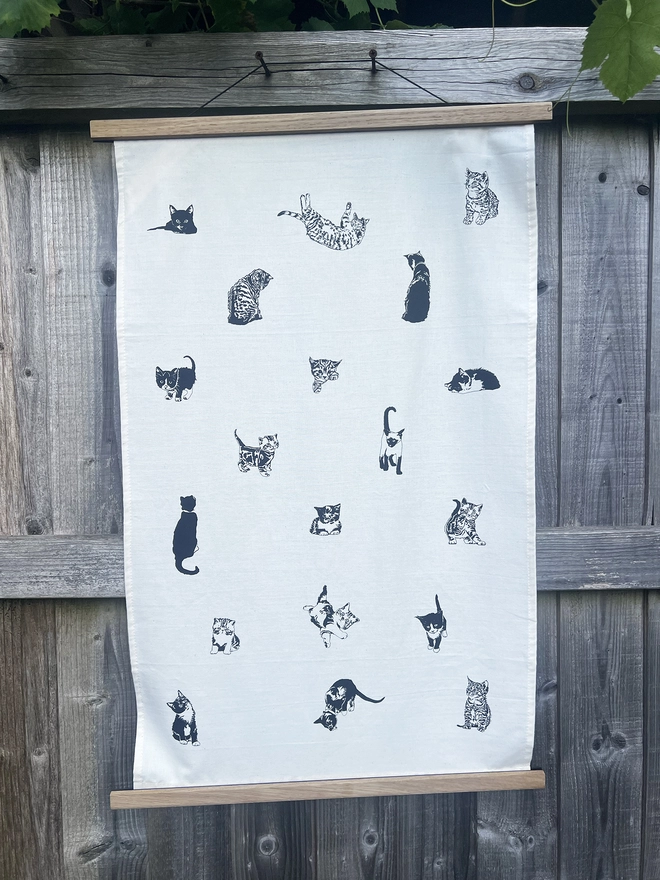 Tea towel decorated in a variety of little cats.