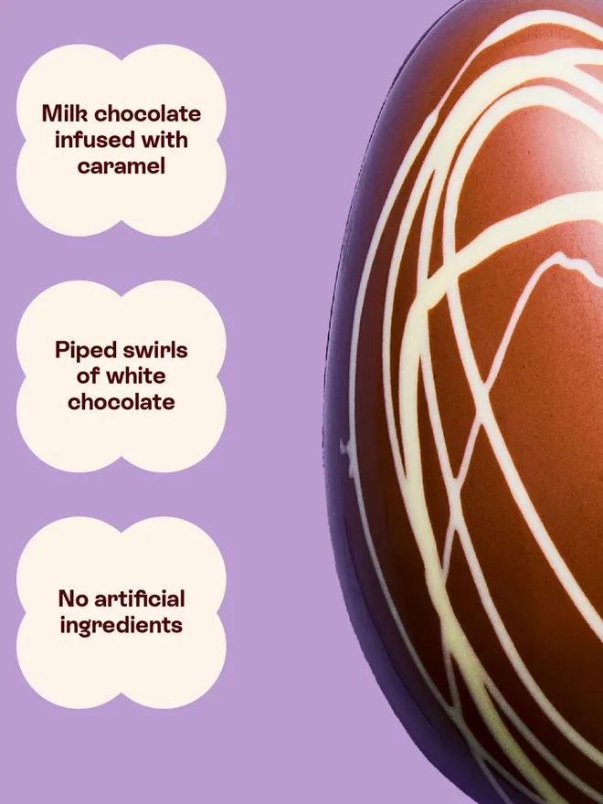 A caramel chocolate Easter egg with white chocolate swirl