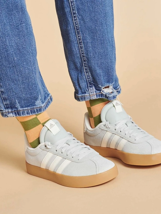 Women's Organic Cotton Ankle Socks Packs (Sets Of 3), a person wearing a pair of colourful patterned socks. 