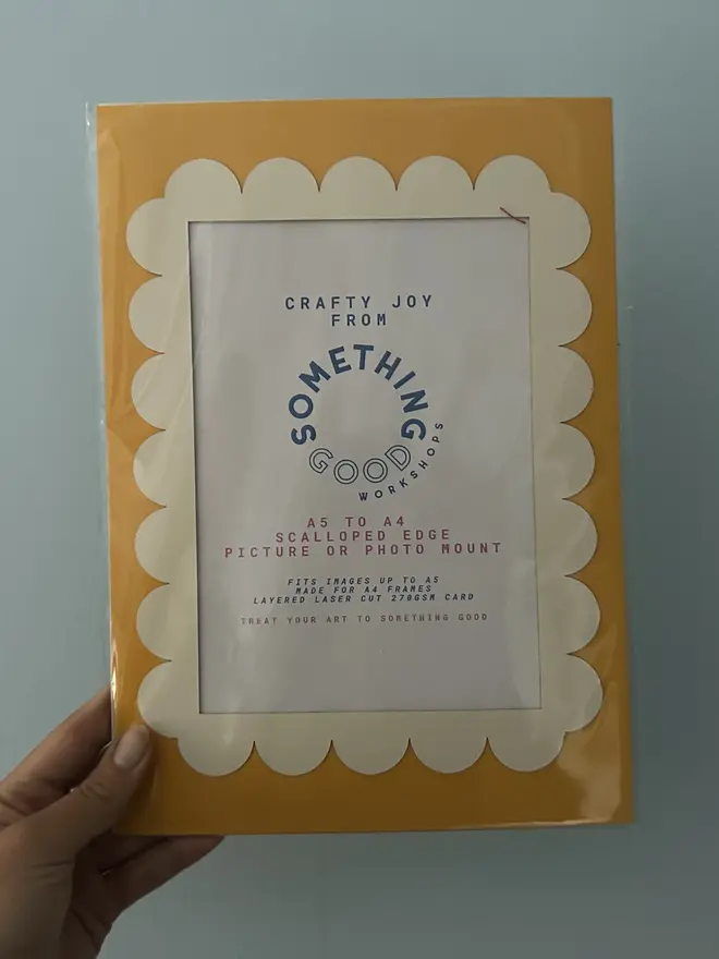 Scallop Edged A5 / A4 photo mount. yellow and white mount held against grey background. 