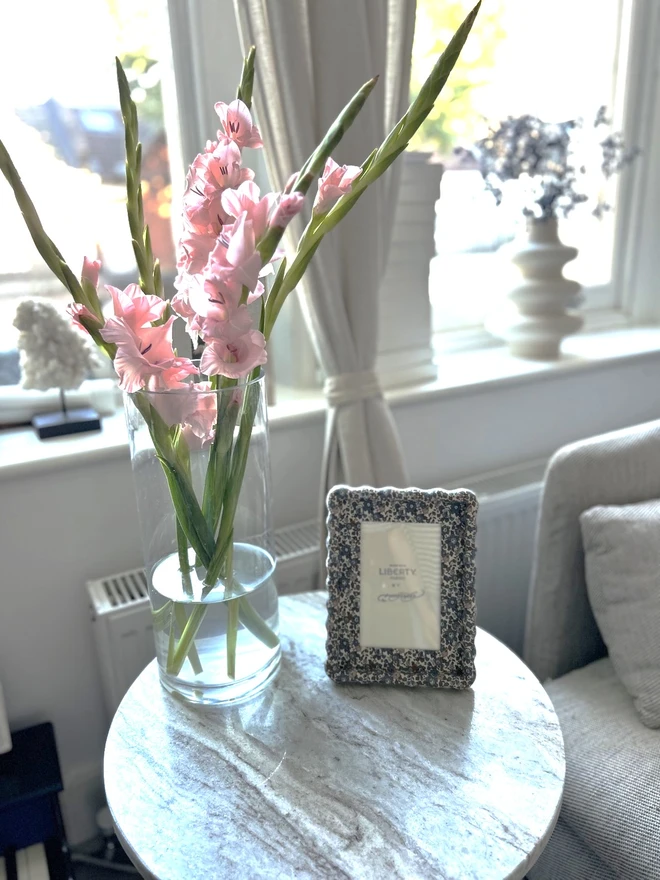 Liberty fabric covered wiggle mount frame displayed on a coffee table