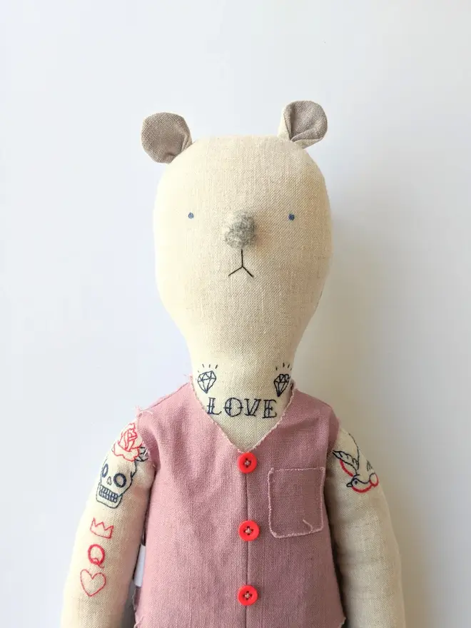 tattooed bear doll. two cream linen bear dolls with embroidered arm and neck tattoos and a pink waistcoat.