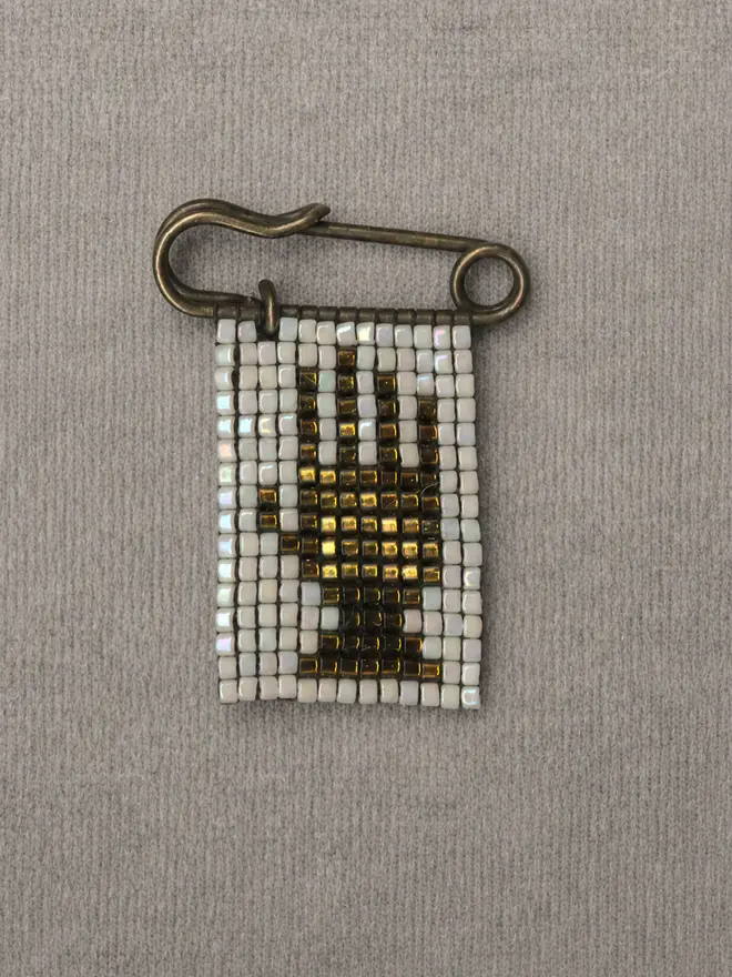 Tiled Beaded 'Hand' Pin on grey back drop