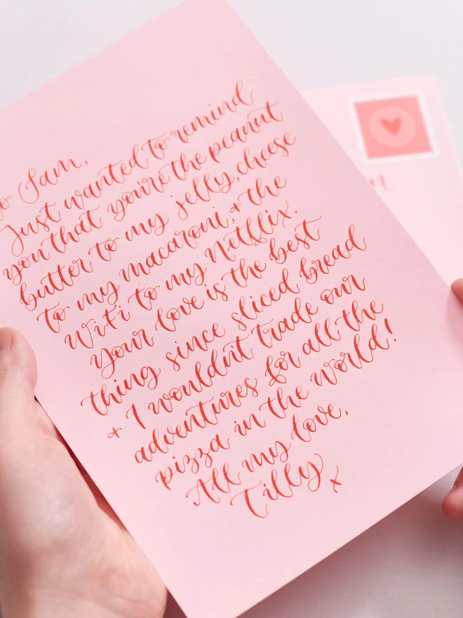 handwritten love letter pink and red calligraphy close up