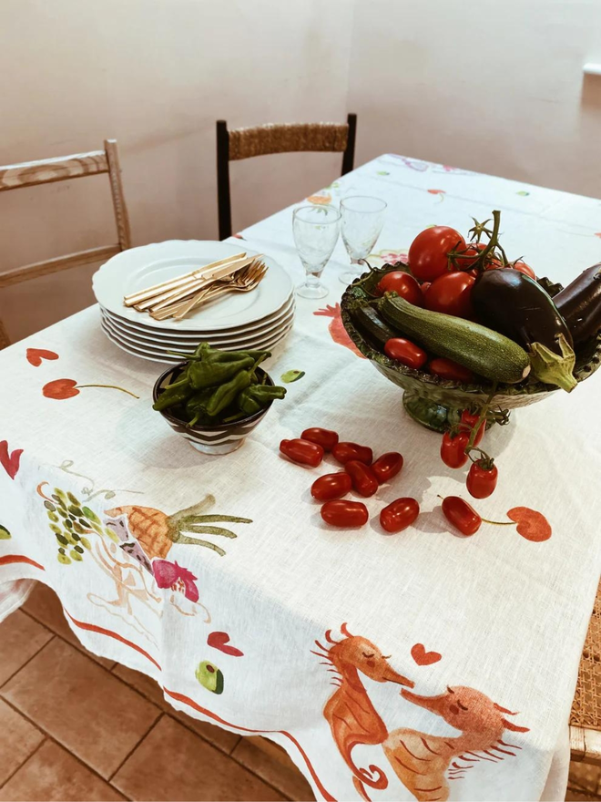 seahorse and fruit multi print linen table cloth on laid table