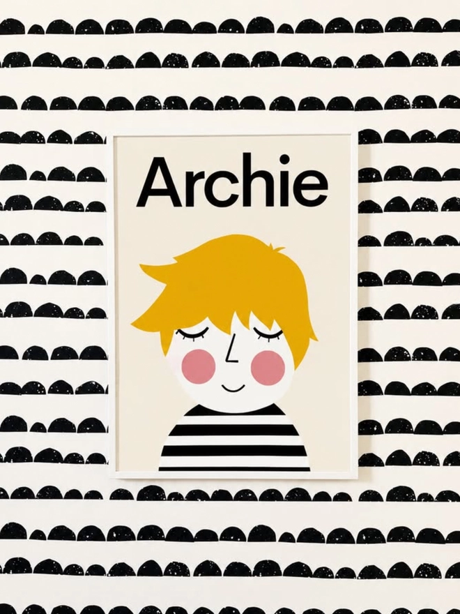 Poster with a personalised illustration of a child with yellow hair and a striped shirt, set against a patterned background.