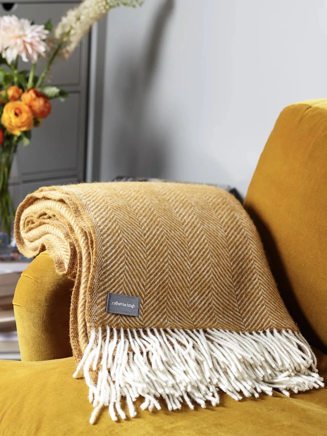 Organic Wool Throw, an organic wool throw sitting on a sofa. 