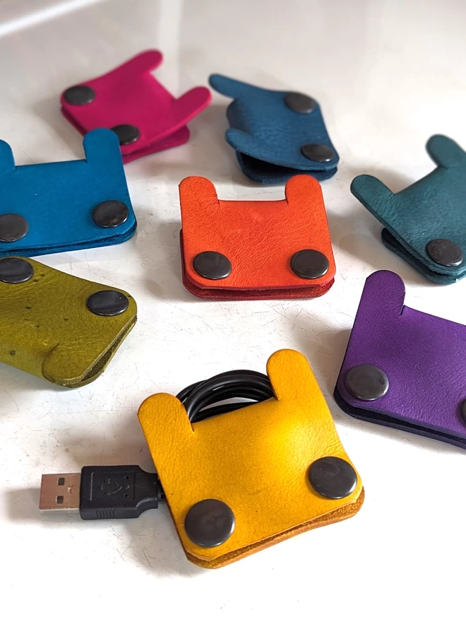Image of leather Bunny cable tidies in an assortment of colours.