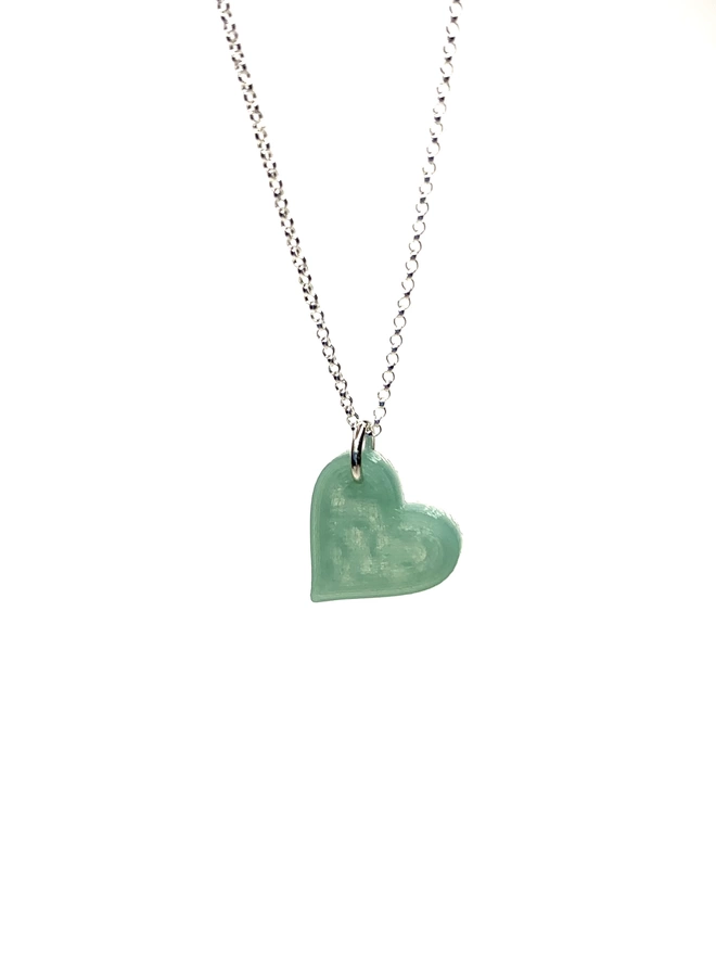 Recycled fishing net heart of a silver chain, necklace, close up