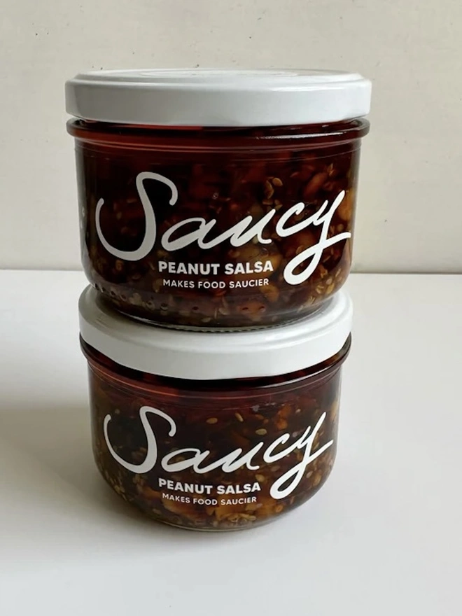 Peanut Salsa (Set Of 2), a pair of peanut salsas sitting on a white table against a grey backdrop. 