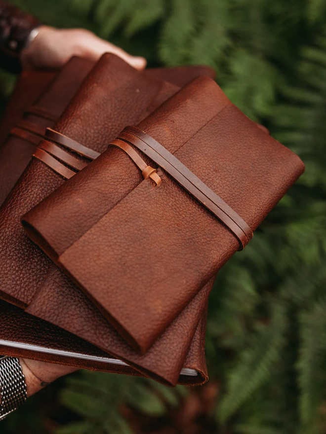 a5 medium leather journal. a stack dark brown journals.