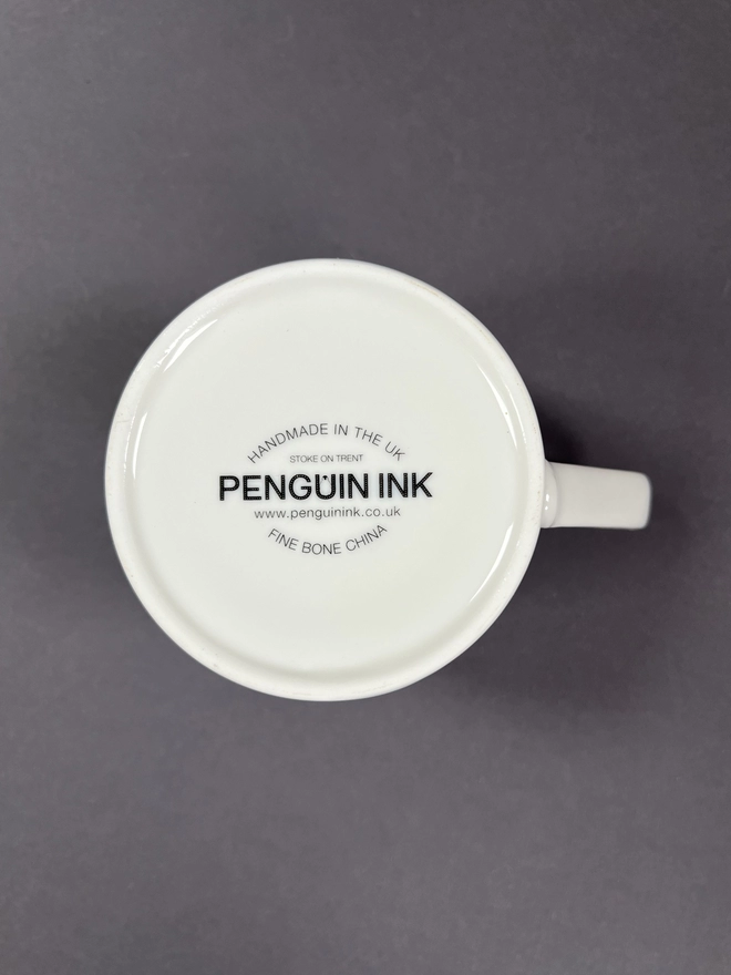 Bottom of the mug showing the Penguin Ink logo decal
