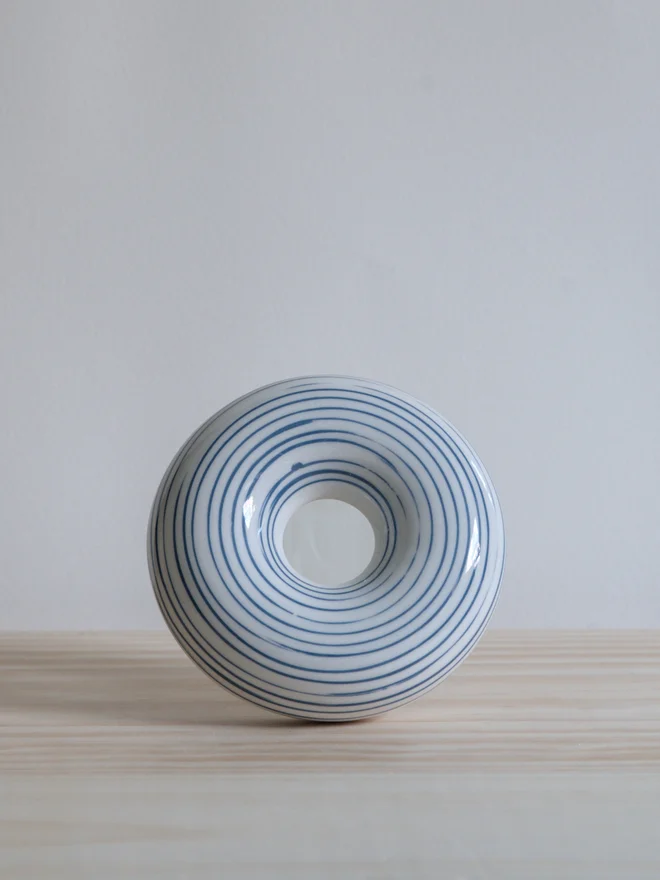 Handmade porcelain avocado planter with carved blue pattern, designed to hold an avocado seed for sprouting