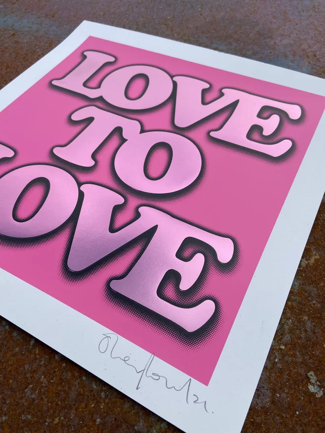 Metallic Hot Foil  "Love to Love" Screen Print in pink. typography says love to love with a drop shadow the print is square 