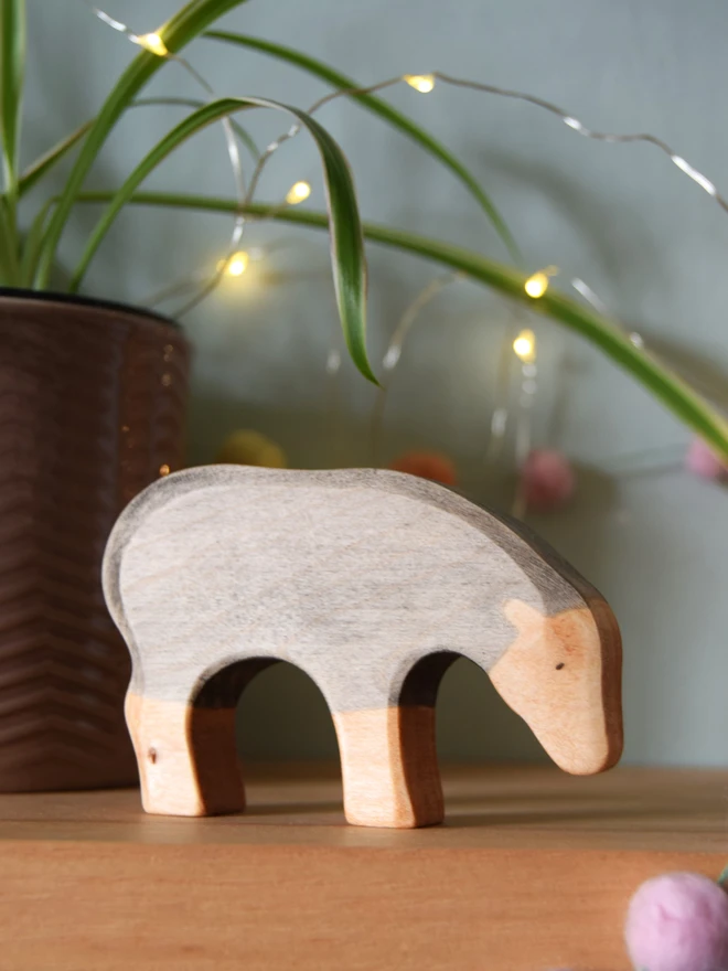 wooden black sheep on shelf