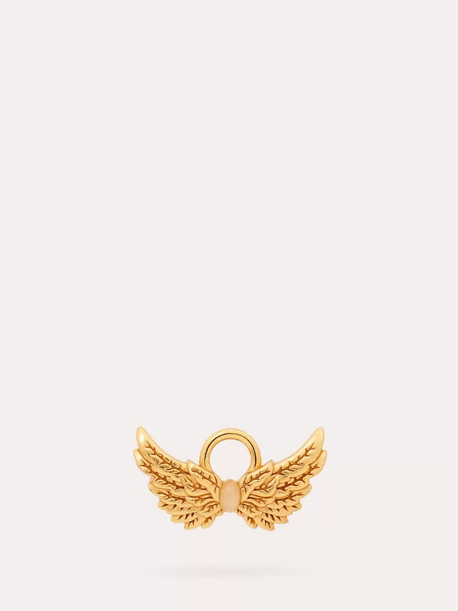 front view of a gold Hermes Wings Charm featuring an opal stone