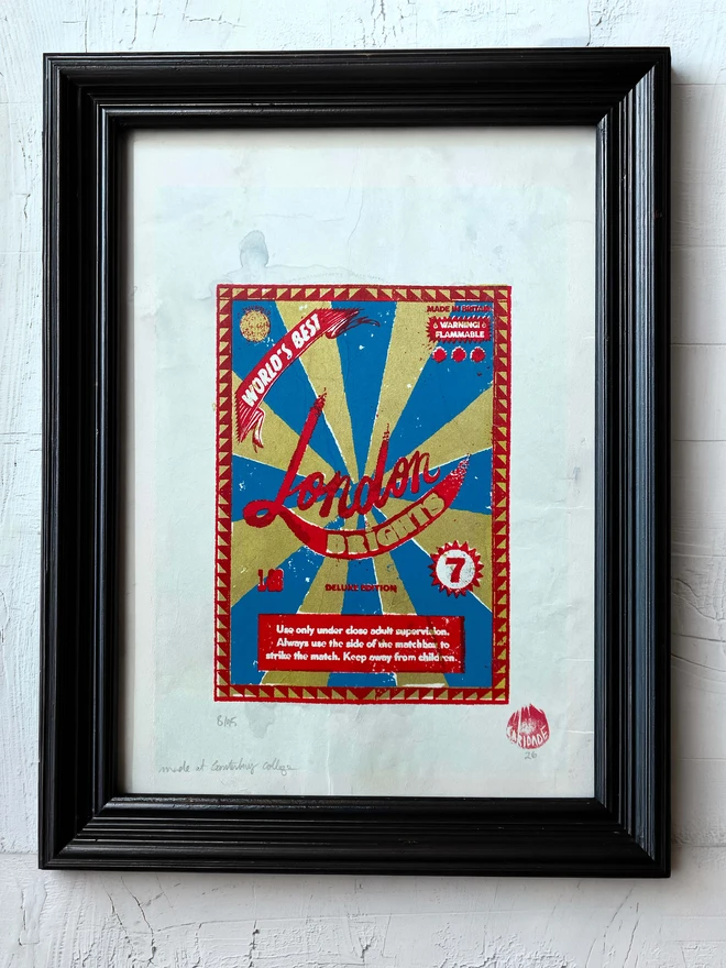Bring a touch of nostalgic British charm to your space with this striking London Brights limited edition screen-print, inspired by the bold graphics of fireworks labels.     Featuring a vibrant palette of red, blue, and gold, the design showcases dramatic sunburst rays and retro typography, capturing the energy and character of classic mid-century advertising.      Each print includes the artist’s signature and edition number, this piece is perfect for lovers of London, vintage design, and unique statement art.