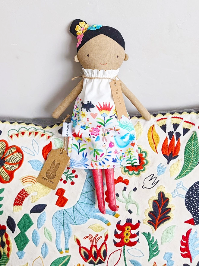 Frida Kahlo doll with colourful dress and tan skin