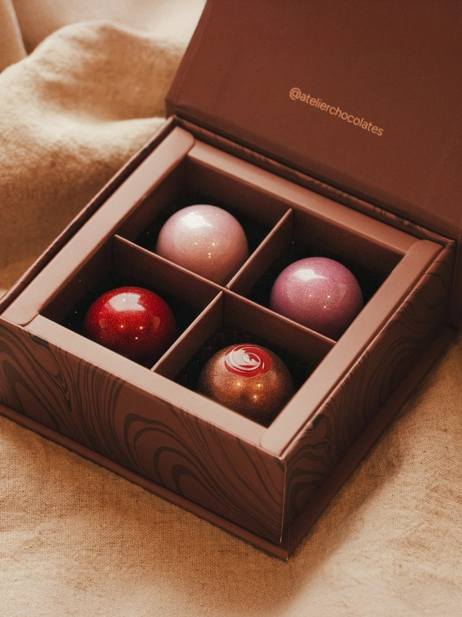 An Atelier Chocolates Valentine's collection of four artisan bon bons.