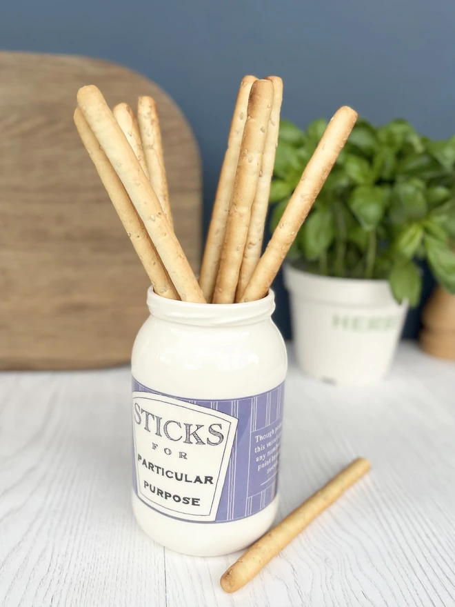 Breadsticks ready for dinner guest in this beautifully handmade stick jar. 