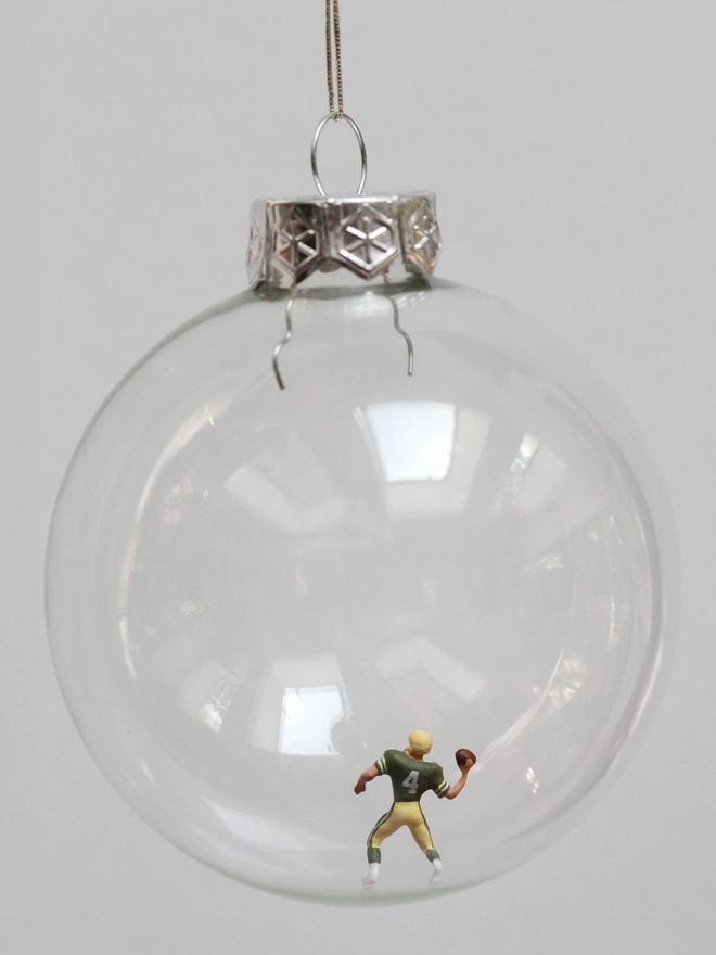 Miniature figure of an American footballer in a glass hanging christmas bauble 