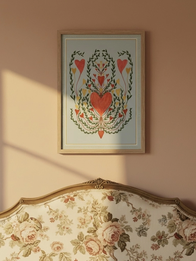 Love In Blue Art Print, a colourful print hanging on a wall. It has a heart motif. 