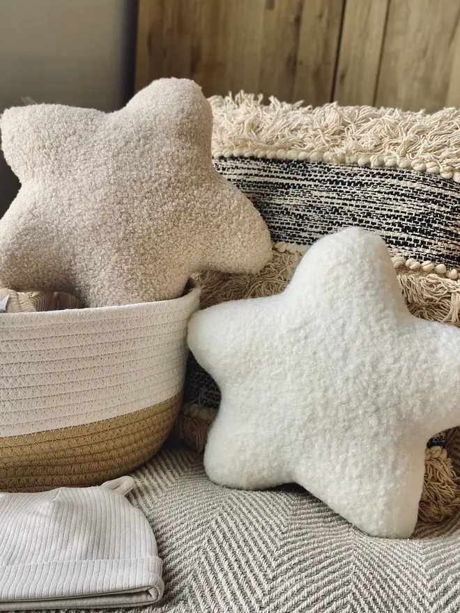 boucle star pillow. two star shaped pillow cushions on a sofa.