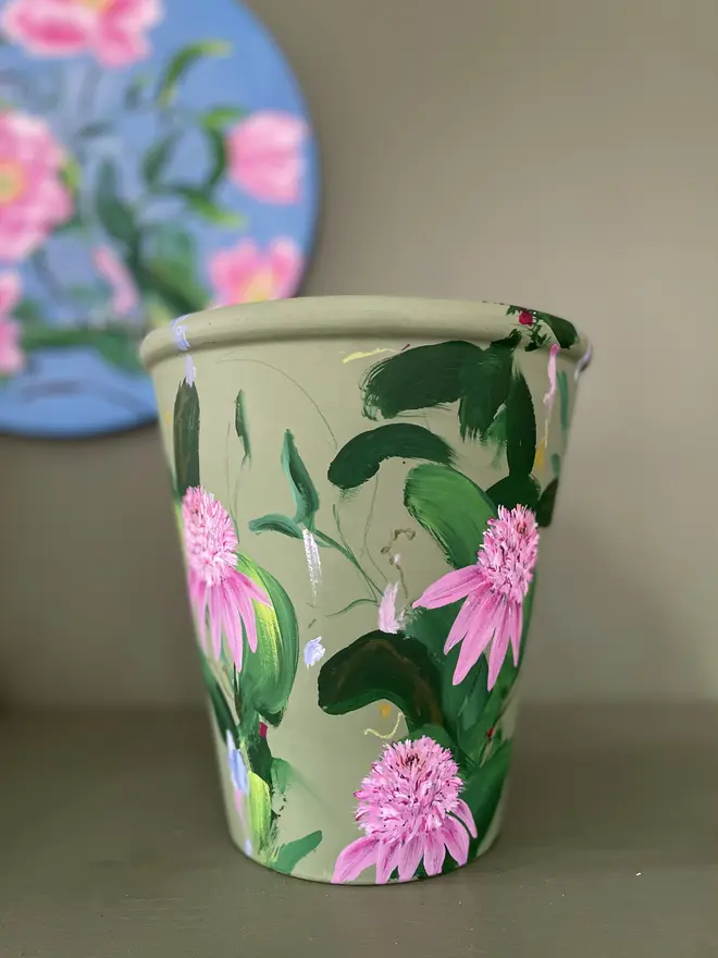 hand painted floral terracotta interior plant pot sage green background with pink pom echinacea flowers