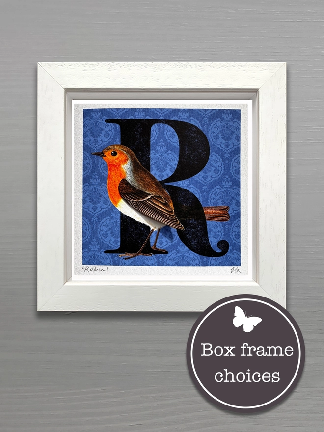 Handmade card with a Robin on a blue background with a big letter R in a white wooden bespoke frame to keep and display the card.